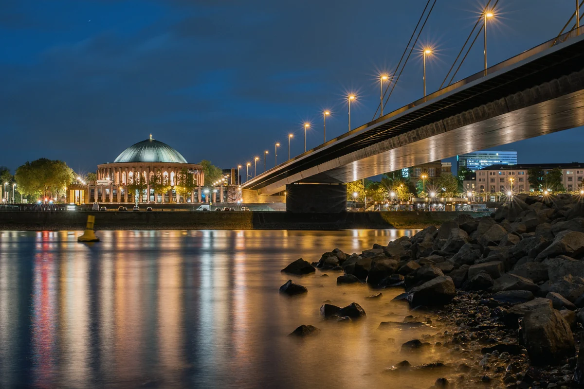 Langzeitbelichtung am Rhein mit der Tonhalle im Hintergrund.